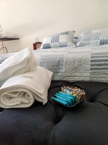 a bed with blankets and a plate of food on it at Green Lodge Eco Life Hotel in Florianópolis