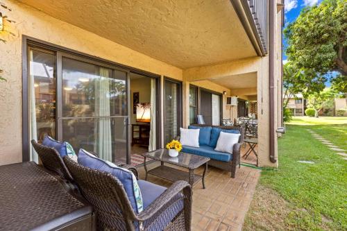 a patio with two chairs and a table on a porch at Charming Tropical Kihei Gardens 2-Bed Suite - New in Kihei