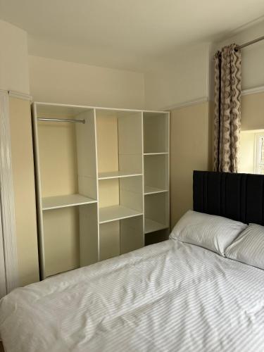 a bedroom with a bed and some shelves at Ye Olde Hotel in Leuchars