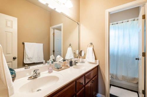 a bathroom with a sink and a large mirror at Casa Vista Chula - Lake Travis - Hot Tub in Buffalo Gap