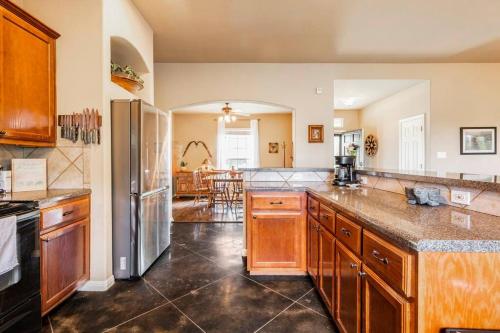 a large kitchen with wooden cabinets and a counter top at Casa Vista Chula - Lake Travis - Hot Tub in Buffalo Gap