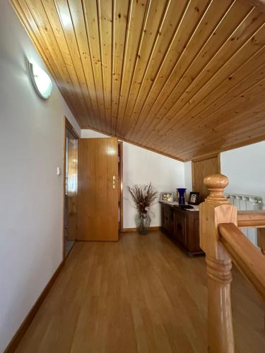 ein Wohnzimmer mit einer Holzdecke und einem Flur in der Unterkunft Quarto em casa em Bragança, Parque eixo Atlântico in Bragança