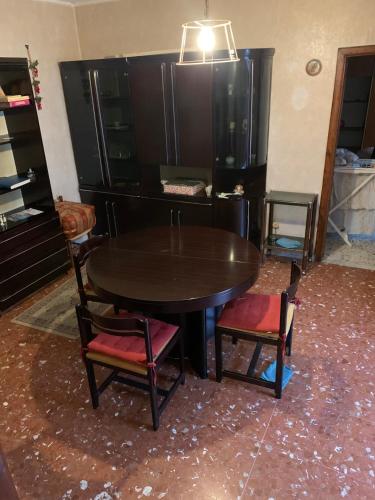 a dining room table and chairs in a room at SURSUM CORDA private house in Orvinio