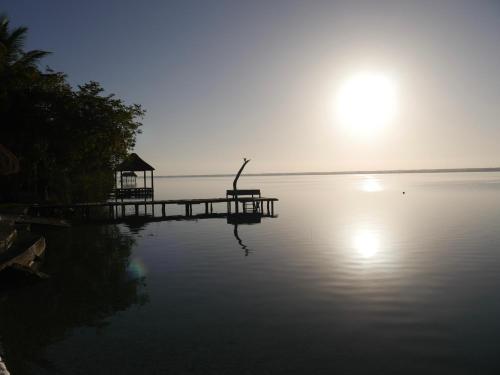 a dock in the middle of a body of water at Villa Santuario Lake front Oasis in Bacalar