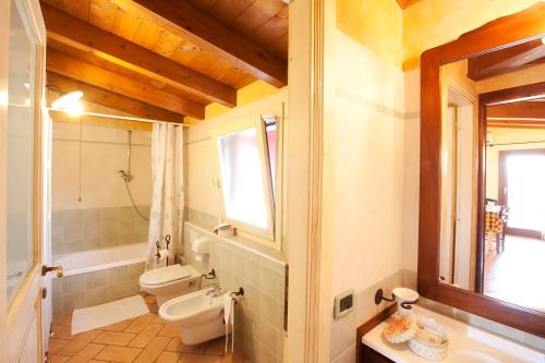 a bathroom with a toilet and a sink at Luna Residence Hotel in Casalmaggiore