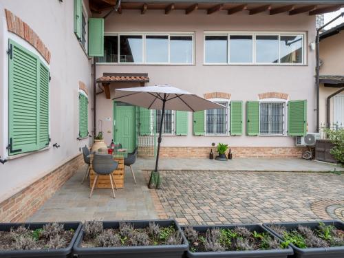 a patio with an umbrella and a table and chairs at Apartment Nonno by Interhome in Portacomaro