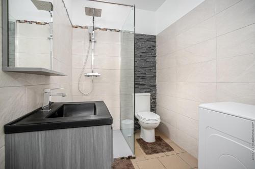 a bathroom with a sink and a toilet at Foyal Toloman - Luxury Lodge in Fort-de-France