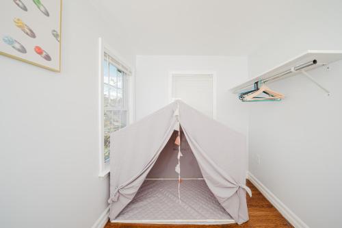 a small white tent in a room with a window at 74L - 2BR Quincy - Cozy Couple Hideout near Wollaston Beach in Quincy