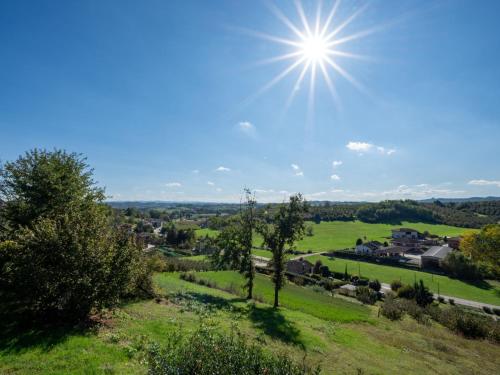 a view of a green field with the sun in the sky at Holiday Home Helix1912 by Interhome in San Damiano dʼAsti