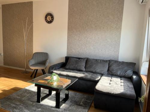 a living room with a couch and a table at LiboroApartments in Niš
