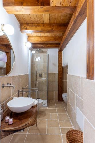 a bathroom with a white sink and a tub at Talassa - Dimora di Charme Suite con vasca idromassaggio in Taranto