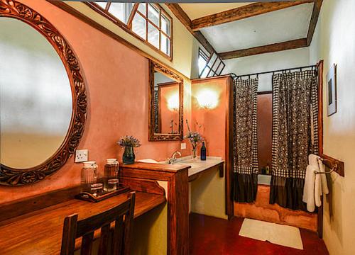 a bathroom with a sink and a mirror at Ngare Sero Mountain Lodge in Usa River