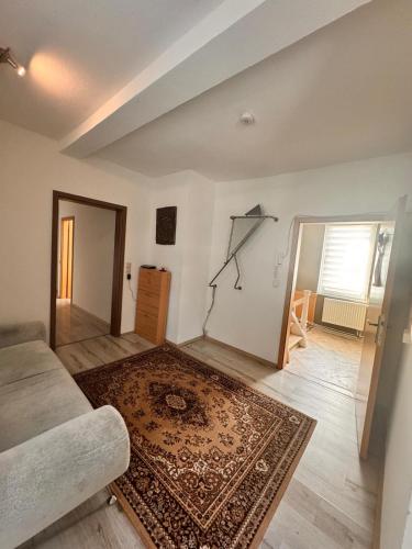a living room with a couch and a rug at Donea Home Service in Schönebeck