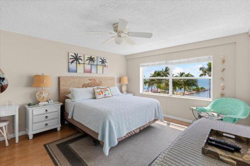 a bedroom with a bed and a window at Oceanfront Oasis in Key West