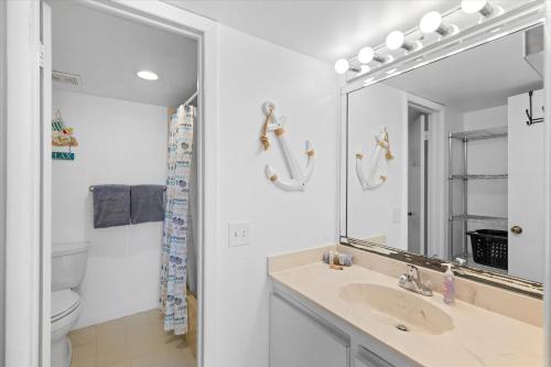 a bathroom with a sink and a mirror at Oceanfront Oasis in Key West