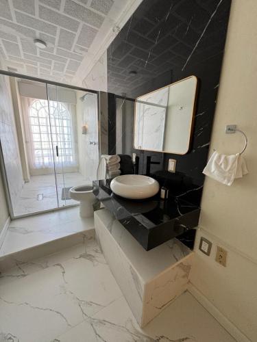 a bathroom with a sink and a mirror at Hotel Casa Monzerrat in Tequila