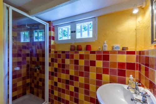 a bathroom with a sink and a shower at Fleurs De Mai Cottage Heated Pool Playgrounds View in Ablon