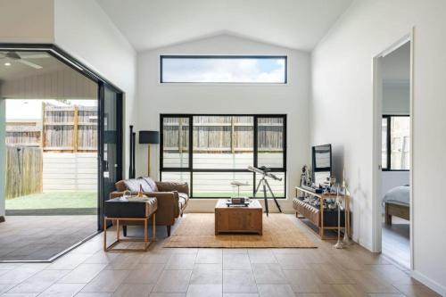 a living room with a couch and a table at New Designer Built Boutique Holiday Home Heathwood in Doolandella