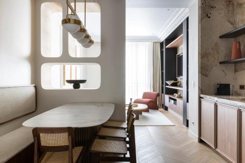 a kitchen and dining room with a table and chairs at HIGHSTAY - Luxury Serviced Apartments - North Marais 2 in Paris