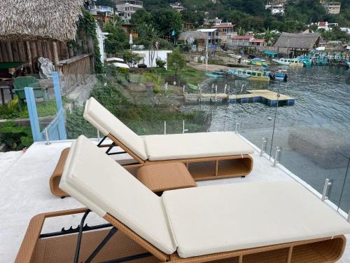 two lounge chairs sitting on top of a boat at Casa Blanca - San Pedro in San Pedro La Laguna
