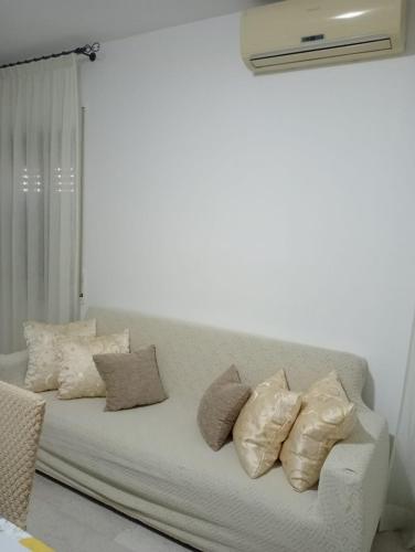 a white couch with pillows on it in a room at Casa Vacanza Luna in Palagiano