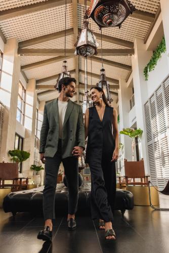 a man and a woman walking in a room at Unico Hotel Riviera Maya Adults Only in Akumal