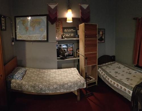 Ένα ή περισσότερα κρεβάτια σε δωμάτιο στο Calcutta Backpackers Homestay- For Travellers and Backpackers