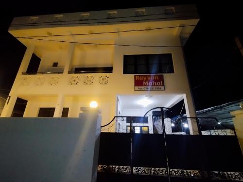 a building with a sign on the side of it at Rayyan Mahal in Puttalam