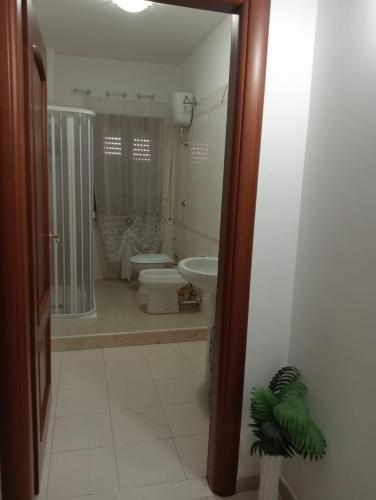 a bathroom with a sink and a toilet and a shower at Casa Vacanza Luna2 in Palagiano