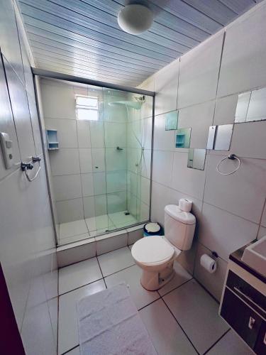 a bathroom with a shower and a toilet at Pousada do Golfinho Fernando de Noronha in Fernando de Noronha