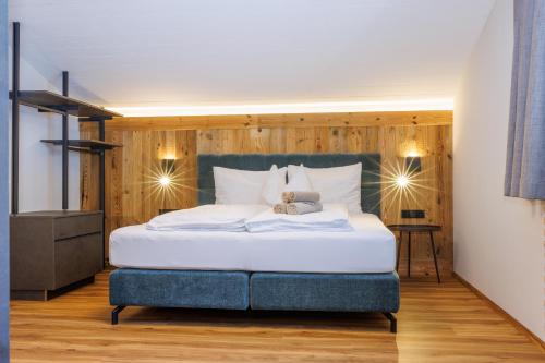 a bedroom with a bed with a teddy bear on it at Ahorn Chalet in Mayrhofen
