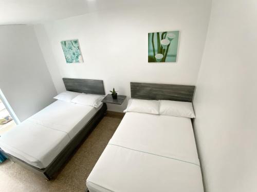 Postel nebo postele na pokoji v ubytování Hotel Plaza Mayor Itagui