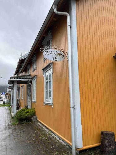 a building with a sign on the side of it at Leilighet i historisk bygning in Mo i Rana