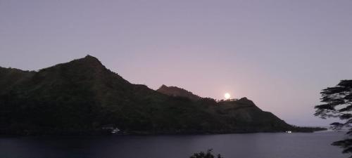 a view of a mountain with a light on top at Vaiterupe Sweet Home in Orufara