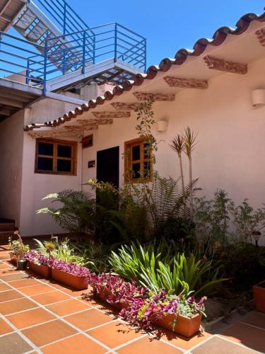 a house with flowers in front of it at Zana Hotel Boutique in Bogotá