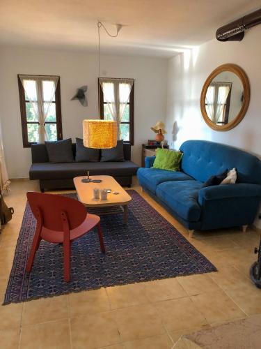 a living room with a blue couch and a table at sea sunset view, walk to the beach in Gümüşlük