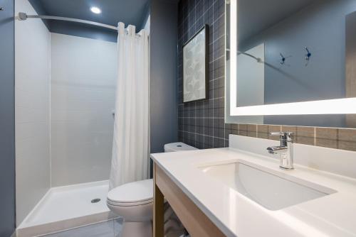 a bathroom with a sink and a toilet at Ardsley Acres Hotel Court in Ardsley