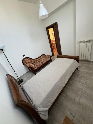 a bedroom with a large bed and a mirror at Appartamento Verde MilliGio primo piano in Marigliano