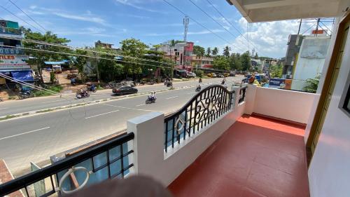 a balcony with a view of a street with motorcycles at KAVIEYA Residency in Pūrnānkuppam