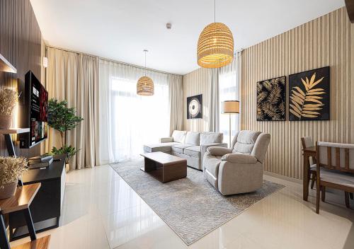 a living room with a couch and chairs and a table at 15BR Serene Escape by Blue Cloud Holidays in Sharjah