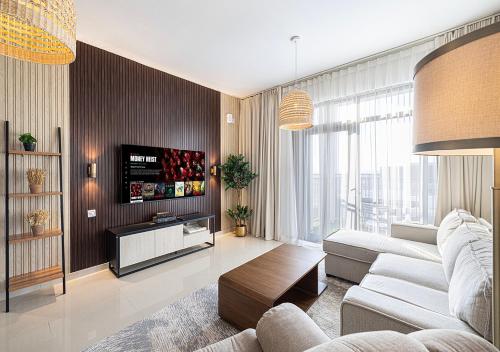 a living room with a couch and a tv at 15BR Serene Escape by Blue Cloud Holidays in Sharjah