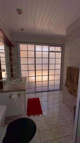 a large bathroom with a sink and a mirror at Vaiata lodge in Arue