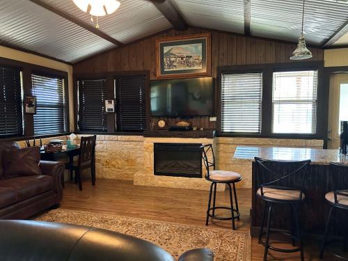 a living room with a fireplace and a tv at Vineyard Trail Cottages- Adults Only in Fredericksburg
