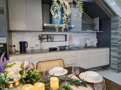 a kitchen with a table with flowers on it at NEW Sunrise Gurney with SEAVIEW 无敌日出海景 in George Town