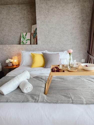a white bed with a wooden tray on top of it at NEW Sunrise Gurney with SEAVIEW 无敌日出海景 in George Town