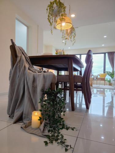 a dining room with a table and a candle on the floor at NEW Sunrise Gurney with SEAVIEW 无敌日出海景 in George Town
