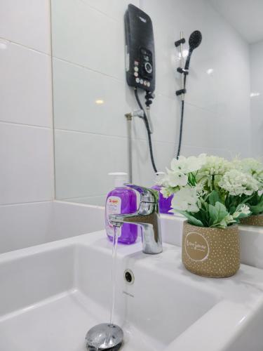a sink with water running from a faucet at NEW Sunrise Gurney with SEAVIEW 无敌日出海景 in George Town