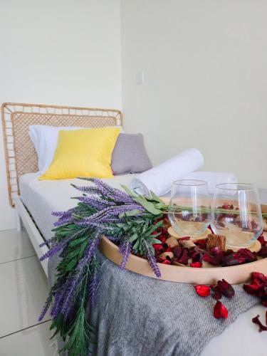 a tray of food and wine glasses on a couch at NEW Sunrise Gurney with SEAVIEW 无敌日出海景 in George Town