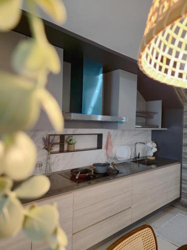 a kitchen with a sink and a counter top at NEW Sunrise Gurney with SEAVIEW 无敌日出海景 in George Town
