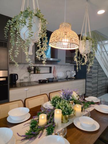 a dining room table with candles and flowers on it at NEW Sunrise Gurney with SEAVIEW 无敌日出海景 in George Town
